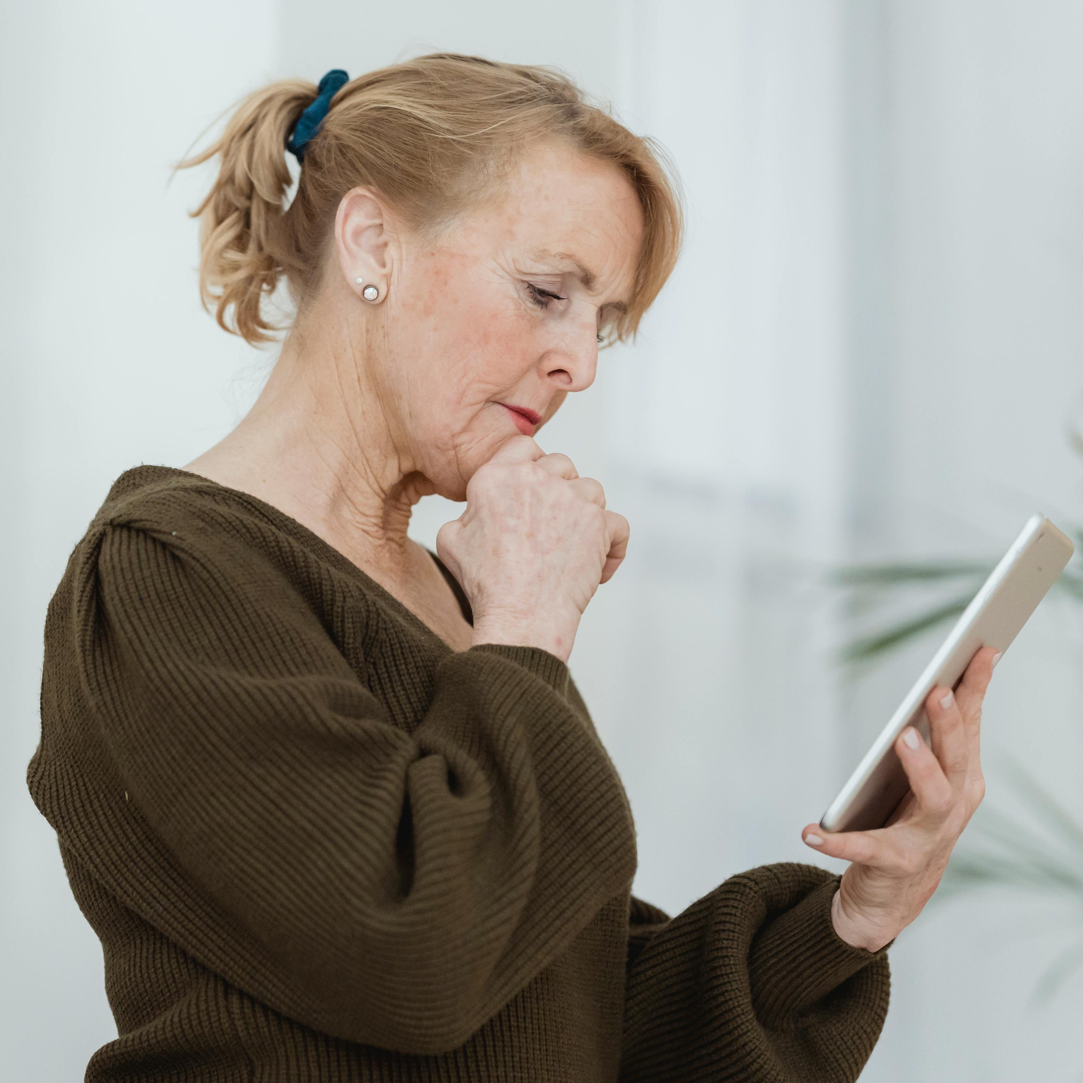 elderly woman using tablet