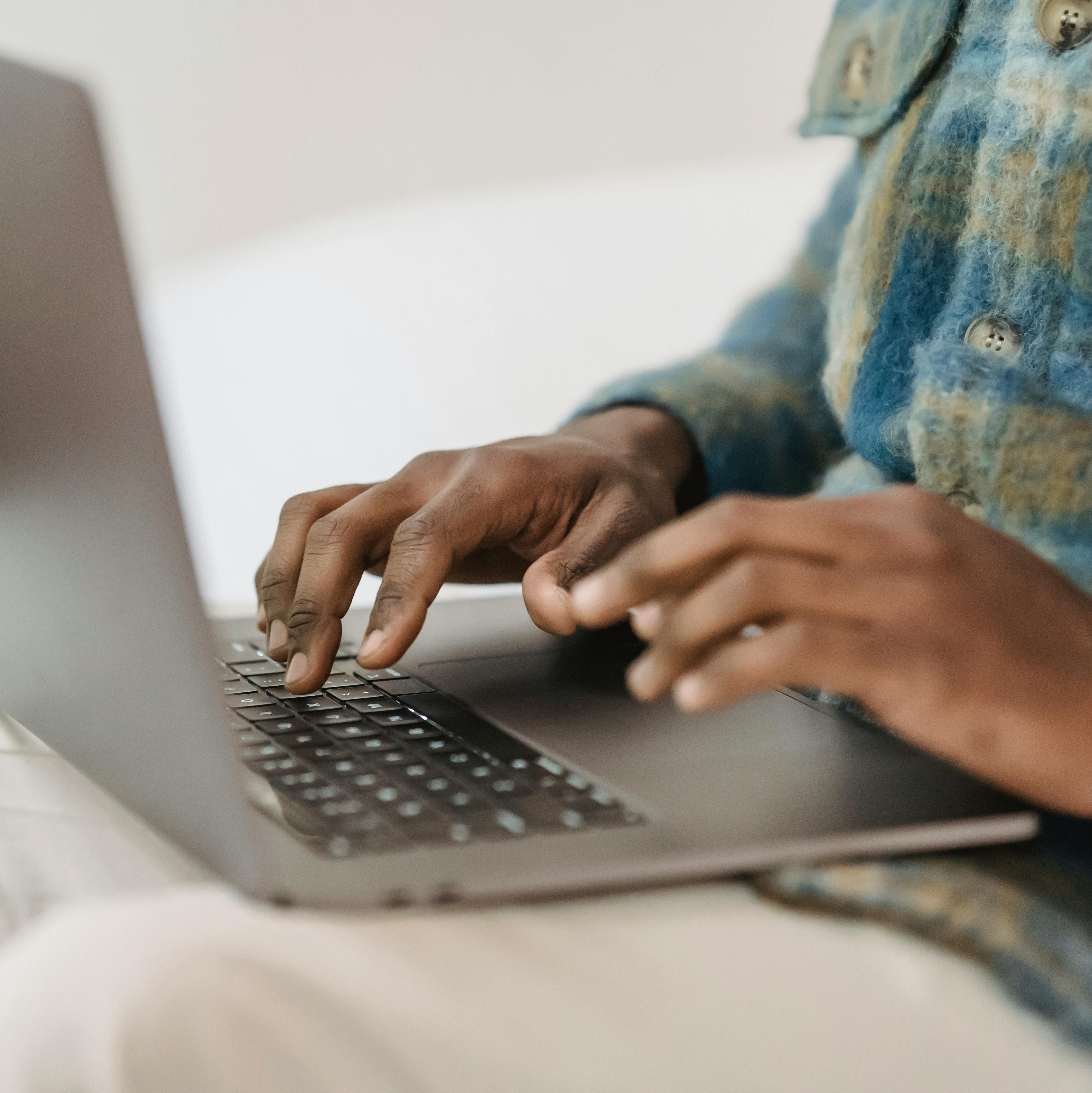hands typing on laptop